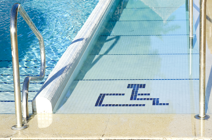 accessibility in hospitality industry. Access to swimming pool for with handicapped symbol