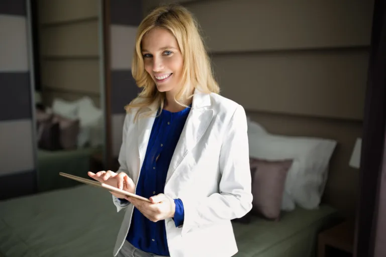Portrait of attractive blonde businesswoman in hotel room